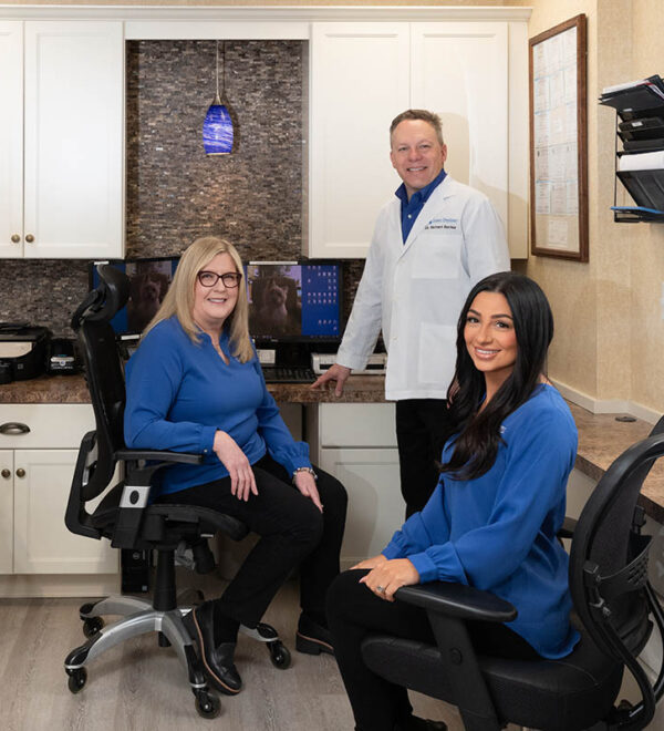 Smiling woman receiving laser cavity treatment in Oakland, NJ